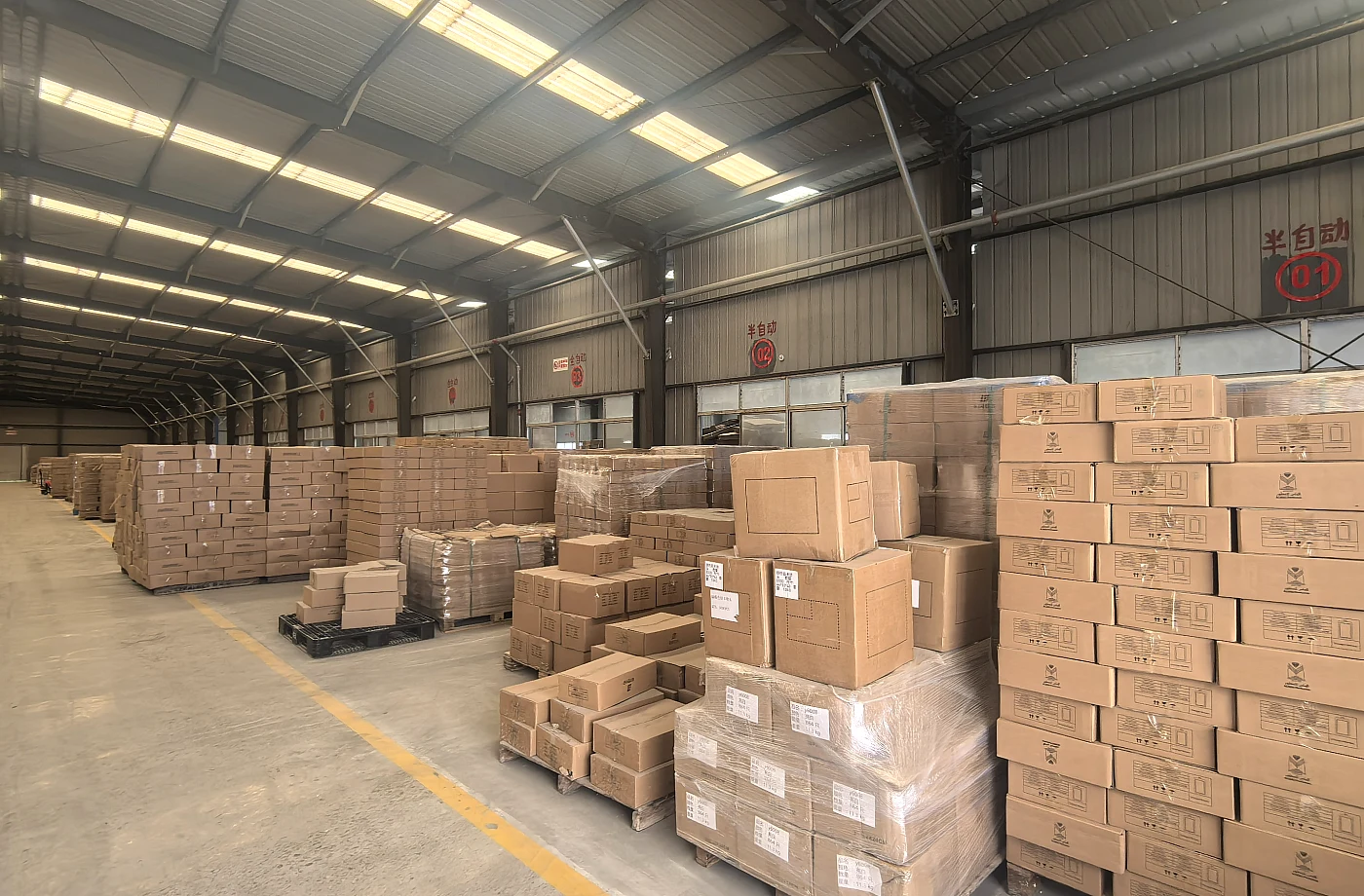 Warehouse with stacked export cartons for glass bottle shipment
