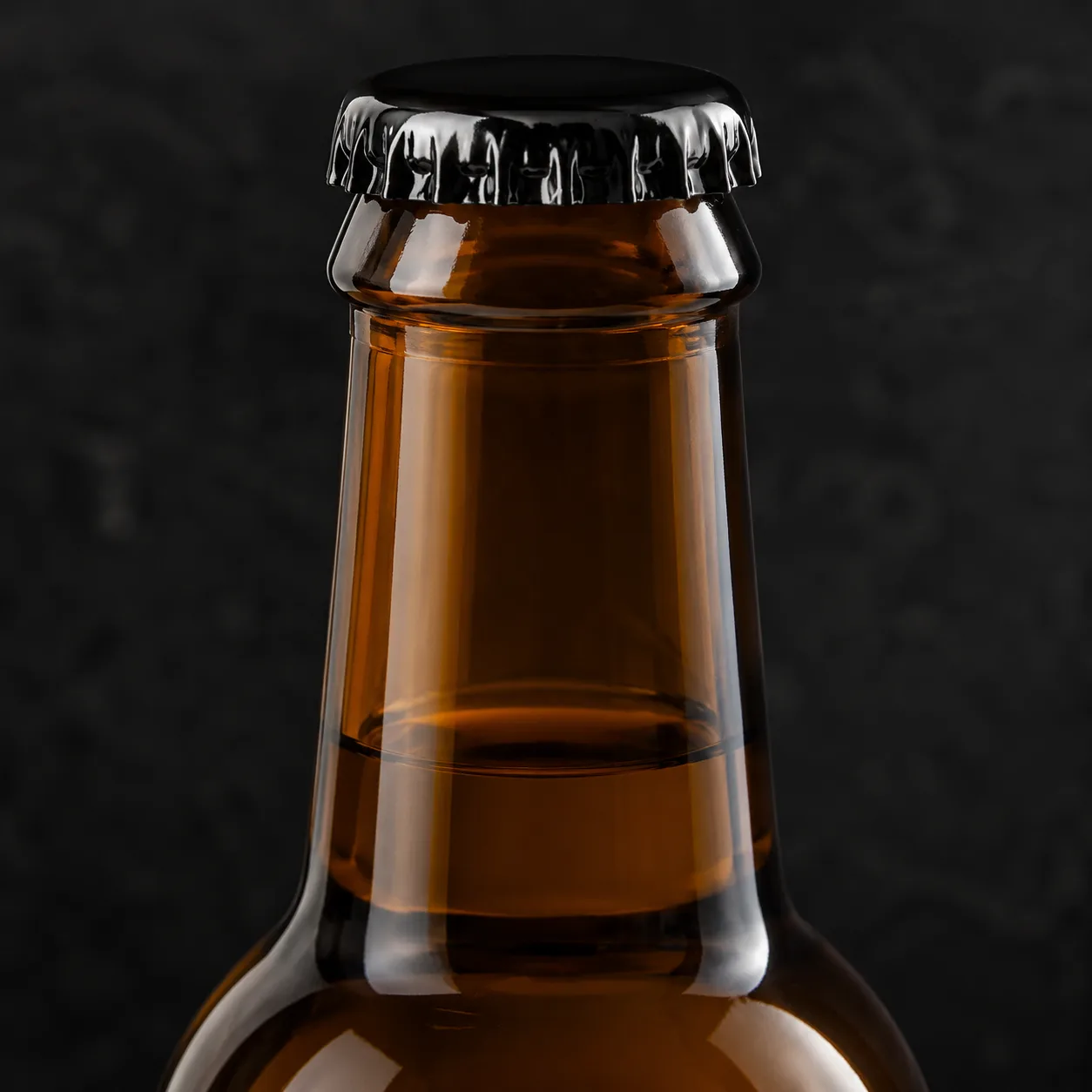 Close view of Amber Glass Kombucha Bottle showing label area and print / coat / label