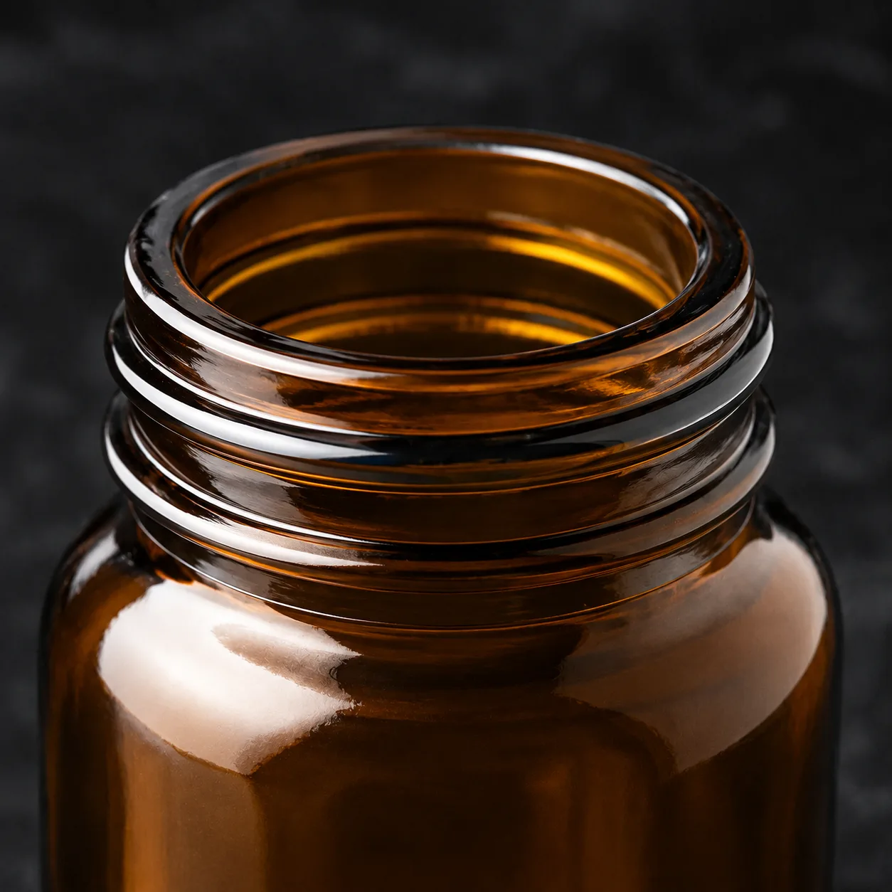 Close view of Amber Glass Tablet and Capsule Bottle showing label area and print / coat / label