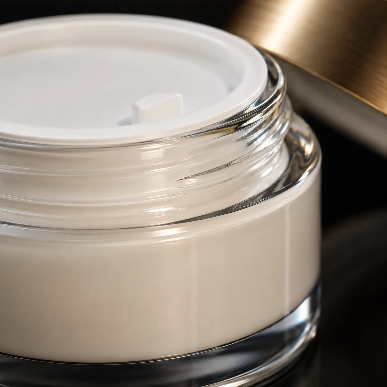 Close view of Glass Eye Cream Jar showing closure area and print / coat / label