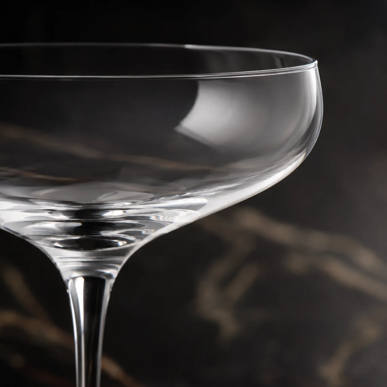 Close view of Coupe Cocktail Glass showing stem or base and logo print / decal