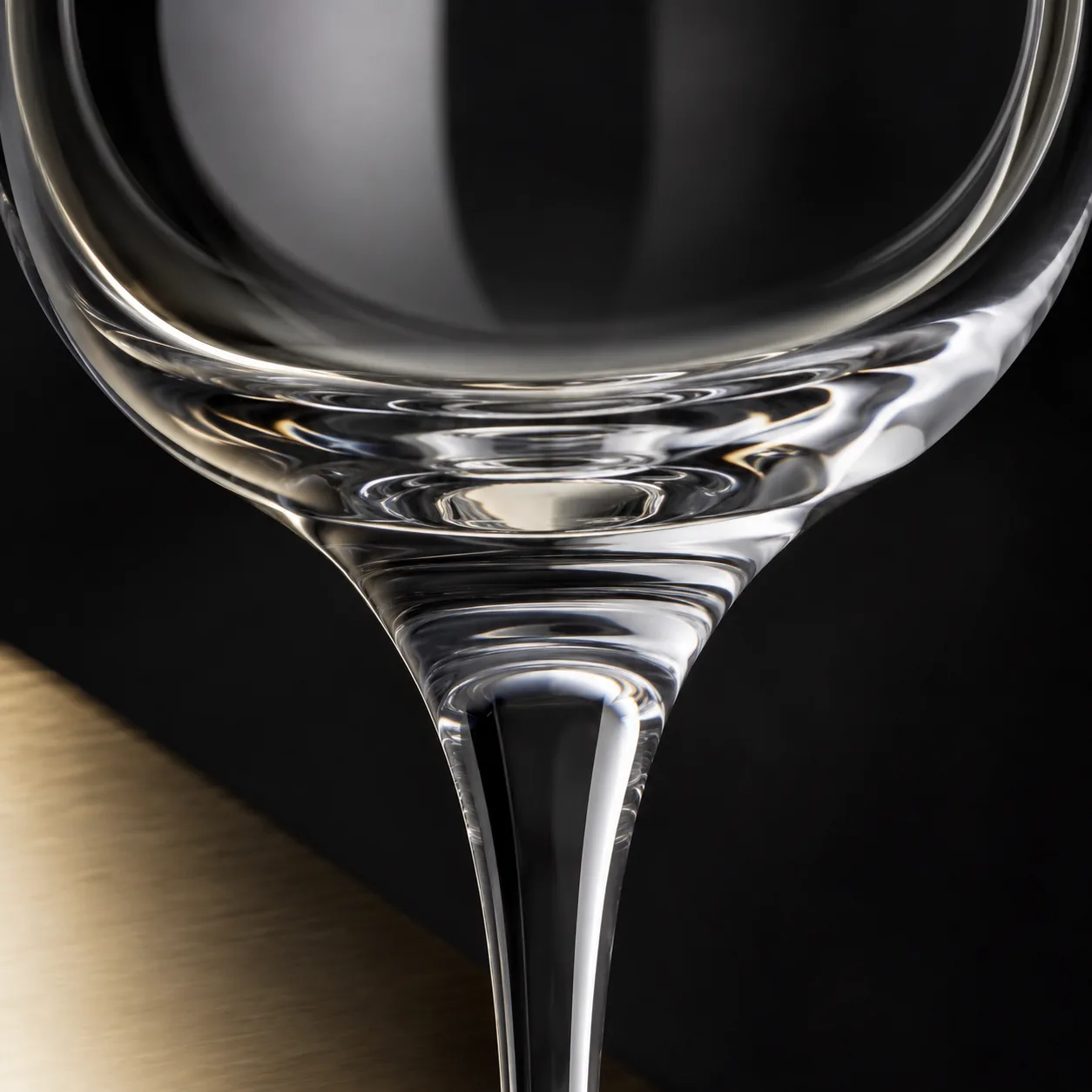 Close view of Nick and Nora Glass showing stem or base and logo print / decal