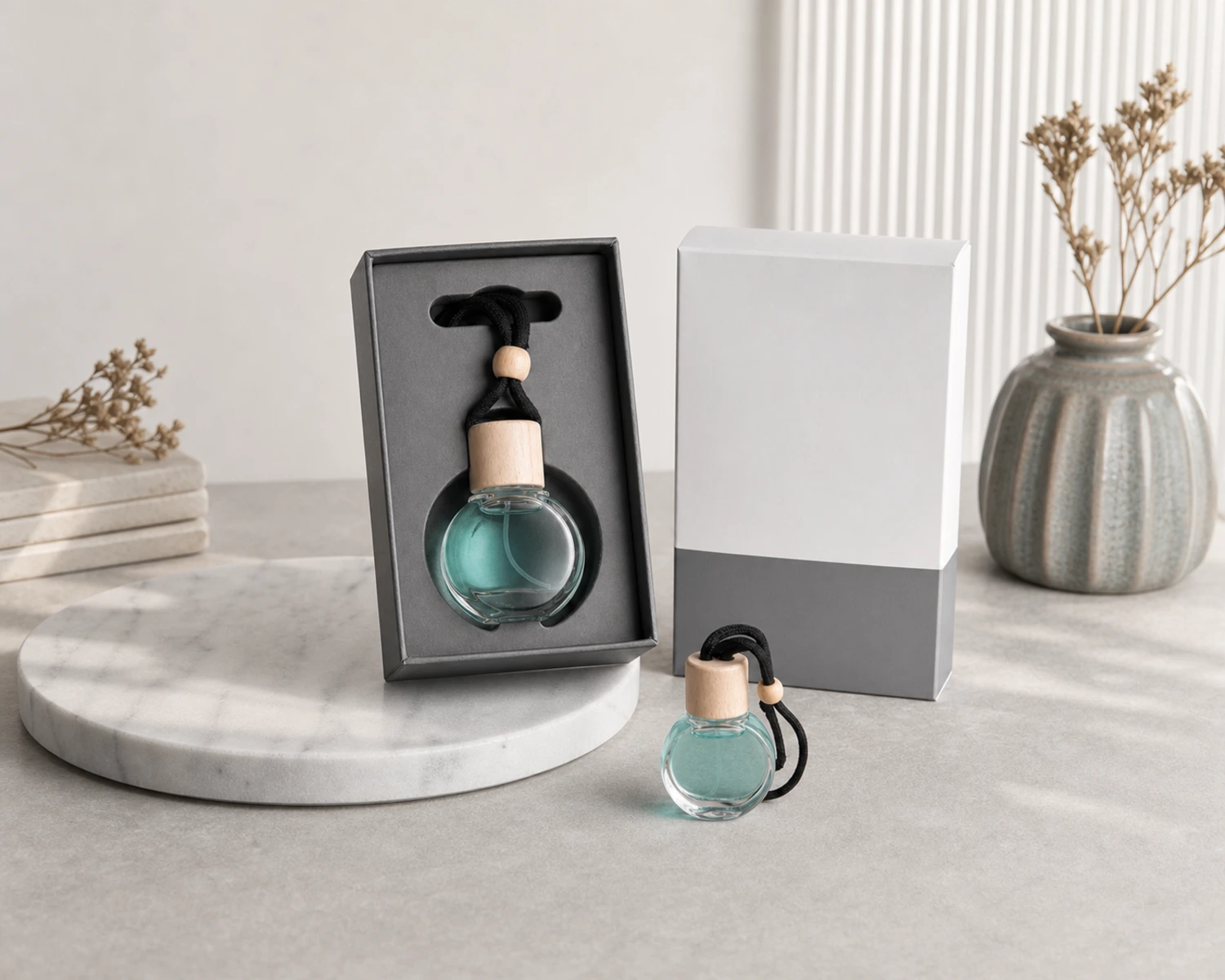 retail packaging image of Round Car Diffuser Bottle showing gift box and shelf presentation