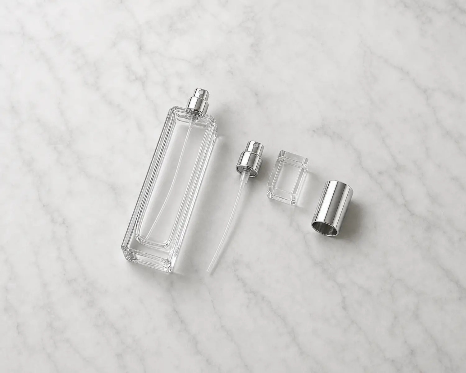 closure detail image of Tall Slim Perfume Bottle showing sprayer, cap and fragrance packaging components
